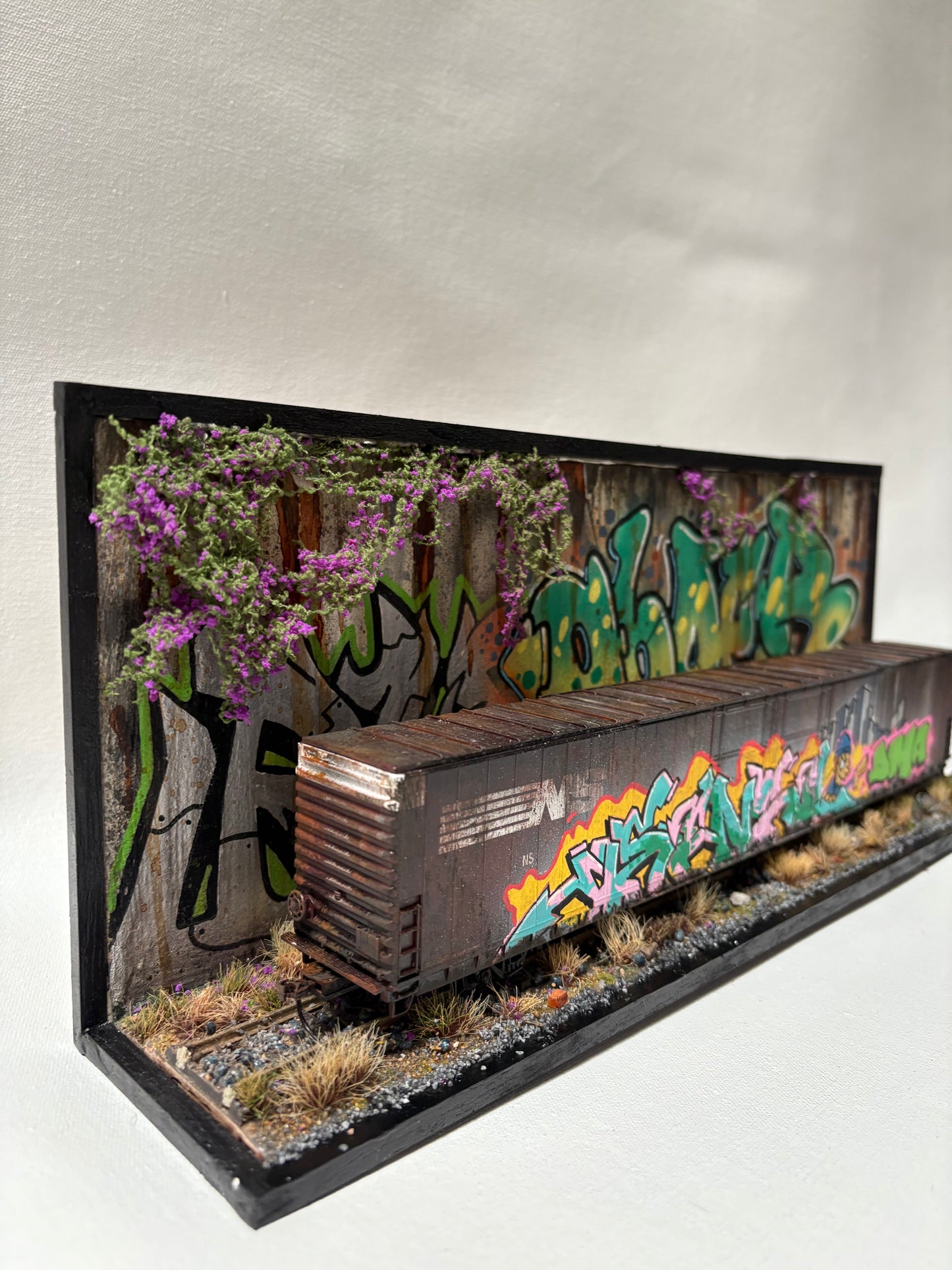 Miniature Model Railroad car and background.