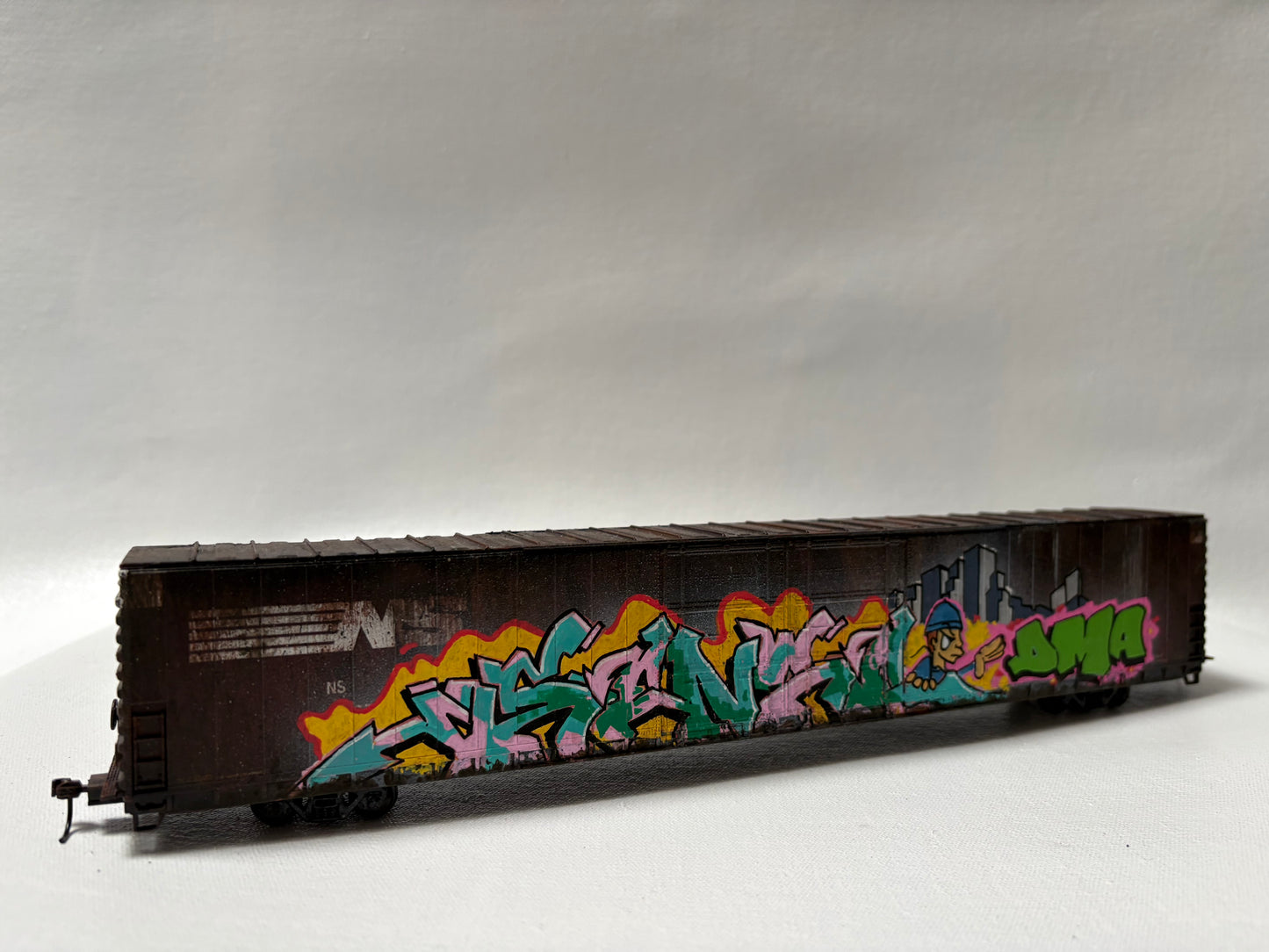 Miniature Model Railroad car and background.